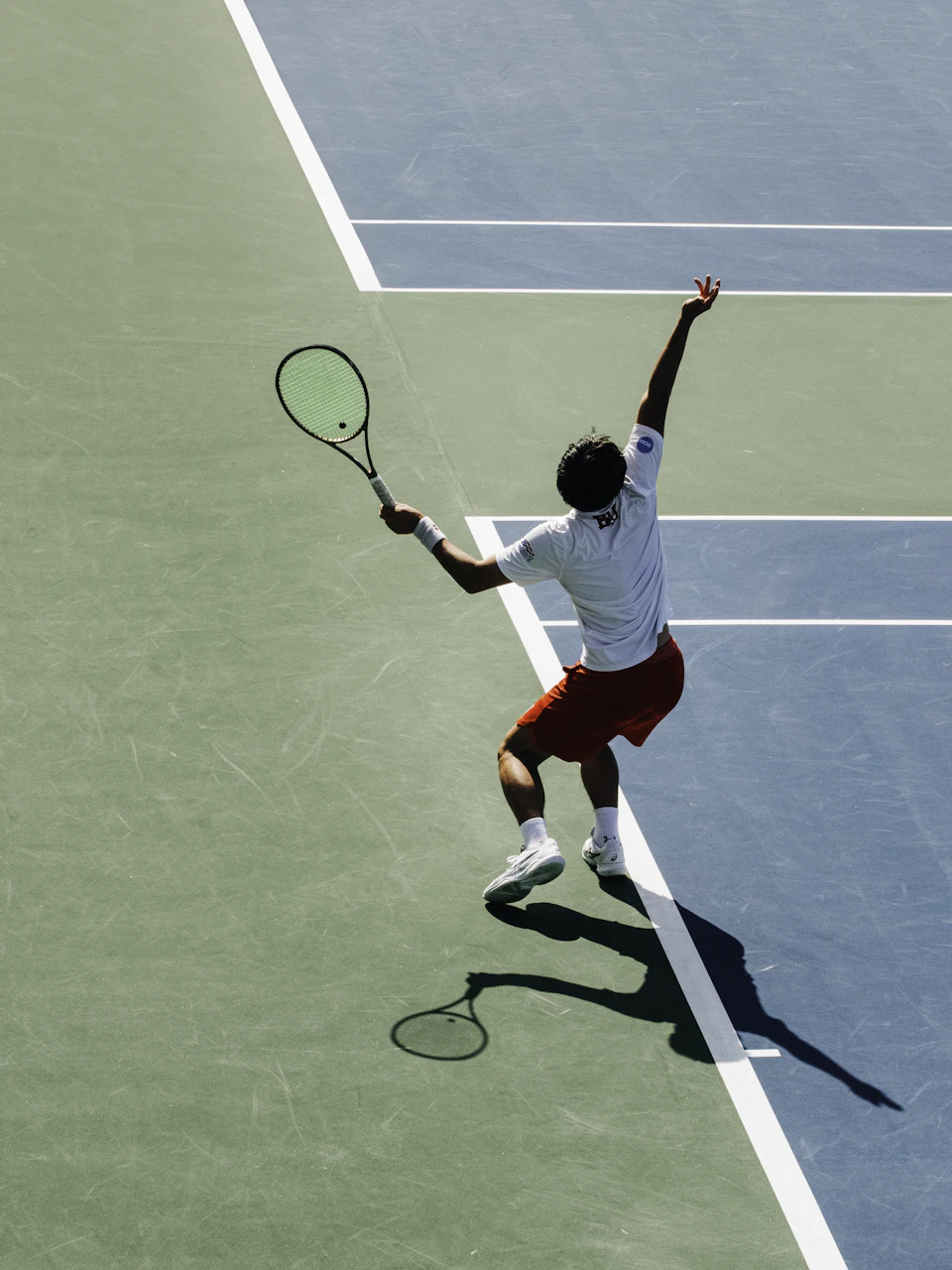 A tennis player tossing the ball to serve